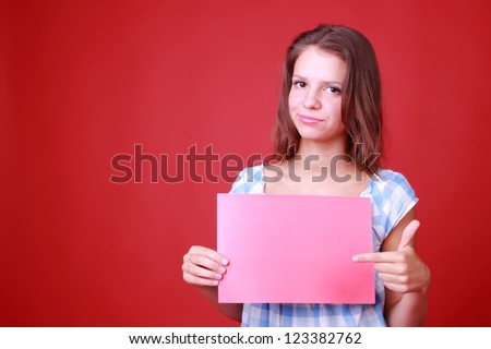 Casual woman with red blank over red background on Background and Texture theme