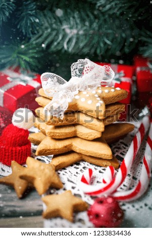 Merry Christmas and happy New year. Cookies gifts and fir tree branches on a wooden table. Selective focus. Christmas background.