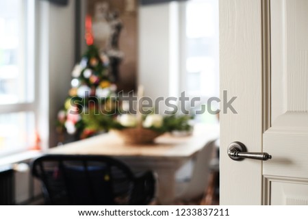 Open door to room with Christmas tree