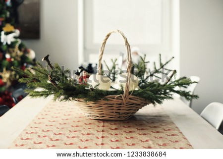 Fir branches in a large basket on the table at Christmas