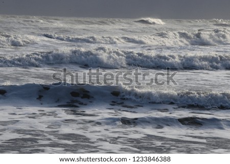 Close up front view of the mediterranean sea during a sunny windy day. Pattern of white waves and splashes with sunlights. Symbol of movement. Abstract picture. 