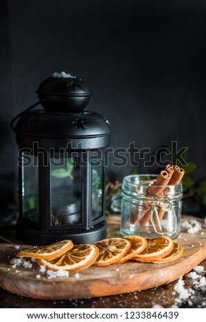 Vintage lantern with cinnamon on dark background