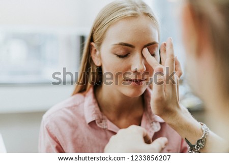 Female model getting her makeup done