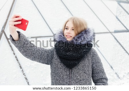 Selfie time, Young funky blogger is making photo for her social networks page. Young happy woman taking selfie. Cold sunny weather. Woman winter concept.