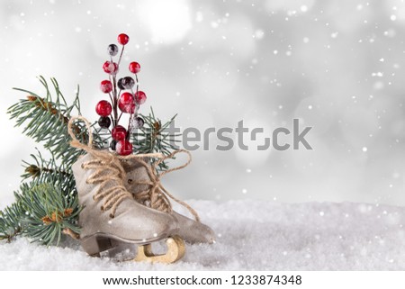 Christmas decoration ice skates on wooden background, lots of copy space for your product or text.