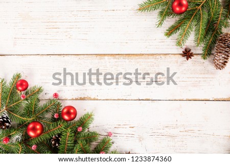 Christmas spruce branches decoration on wooden background, lots of copy space for product or text.