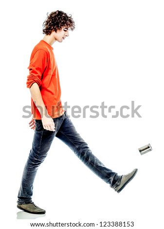 one young man caucasian kicking tin can sad bore side view   in studio white background Royalty-Free Stock Photo #123388153