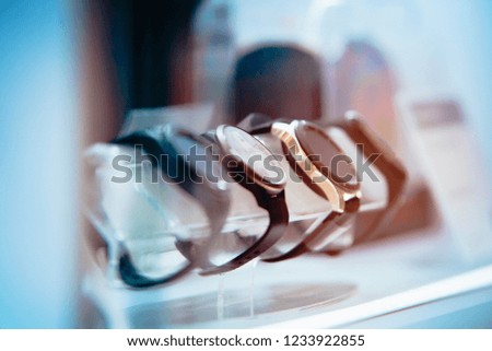 Smart watch behind glass, blue colors