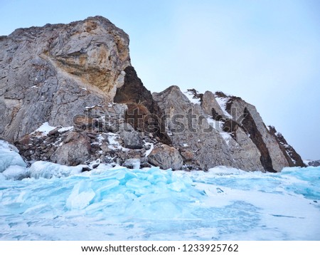 Fantastic Turquoise blue ice block and rock mountain at Lake Baikal in Olkhon Island, Russia. Defocus picture.