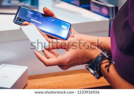 Woman holding smart phone. Detail photo