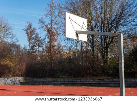 Autumn in a park with basketball court