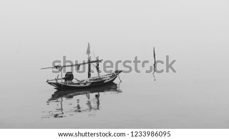 Amazing fine art black & white landscapes photograph of a fisherman boat on the beach at Pantai Kenjeran, Surabaya. (noise grain soft focus motion blurry due to long exposure) Nature composition