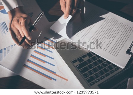 Businessman at workplace Think business investment plan.Contact Investor using cell phone,computer.make note of appointment information in the notebook.design creative work space 
