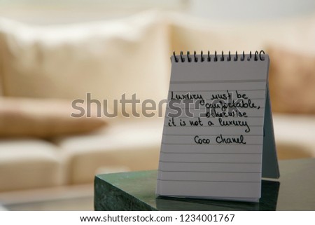 Coco Chanel quotes written on a block note, inspiration phrase "Luxury must be comfortable, otherwise it is not a luxury"