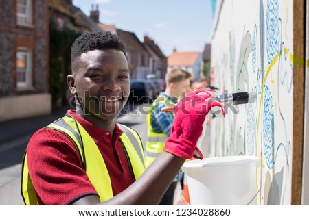 Group Of Helpful Teenagers Creating And Maintaining Community Art Project Royalty-Free Stock Photo #1234028860