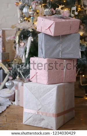 gray and pink gift boxes near the Christmas tree