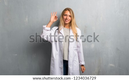 Young doctor woman showing an ok sign with fingers