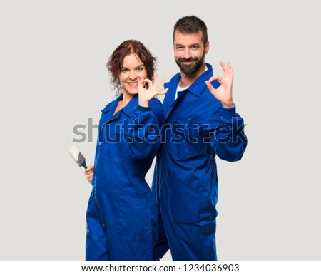 Painters showing an ok sign with fingers on isolated grey background