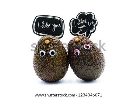 Romantic avocados couple with googly eyes and speech bubbles with text, funny food and love concept for creative projects.