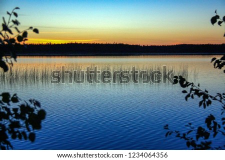 Sunset on the lake every minute changing colors. Karelia
