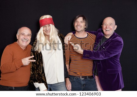 Group of happy male friends against black background