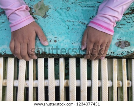 Girl hand grab the pool edge,  Drainage gutter with lichen.