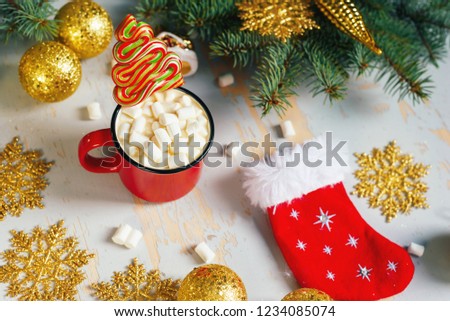 Christmas. Christmas background. Happy New Year. Holiday Red mug with hot chocolate white marshmallows and candy in the shape of a Christmas tree. Selective focus.