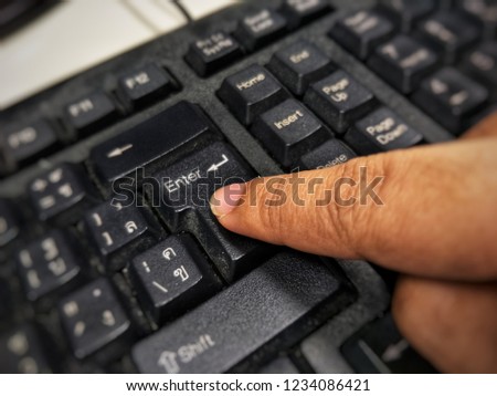 finger pressing button Enter Thai keyboard with blur background 