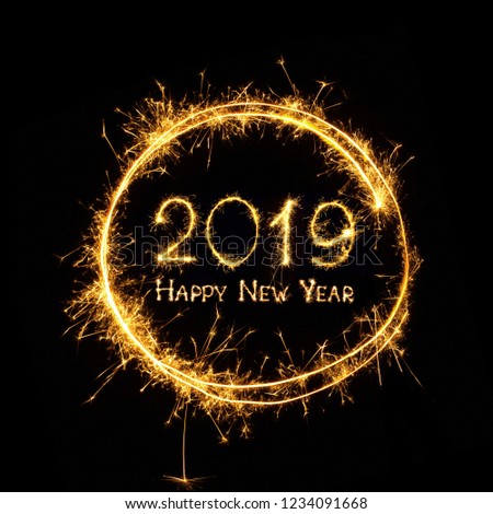 Happy New Year 2019. Golden text Happy New Year 2019 in round frame written burning sparklers isolated on black background for design. Beautiful Glowing overlay template for holiday greeting card.