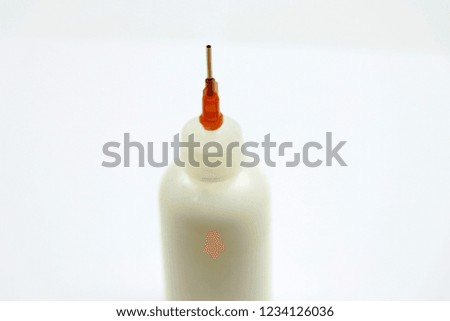 glue bottle with red led , white background