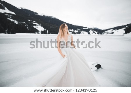 Beautiful bride with a bouquet on mountain background