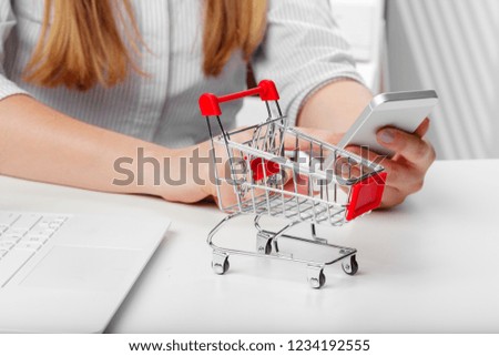 Empty grocery toy  shopping cart on a table