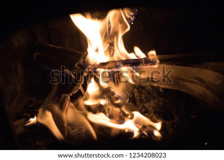 Close Up of Small Fire Crackling and Dancing on Dry Wood in Indoor Fireplace