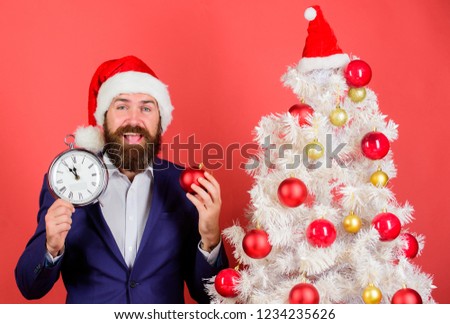 How much time left. Keep track of time. Time to celebrate. Businessman join christmas celebration. Man bearded wear suit and santa hat hold clock. Last minute deals. Counting time till christmas.