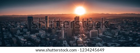 Aerial drone photo - City of Denver Colorado at sunset. Rocky Mountains on the horizon