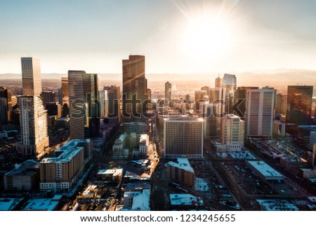 Aerial drone photo - City of Denver Colorado at sunset. Rocky Mountains on the horizon