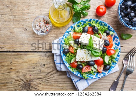 Fresh Greek salad of cucumber, tomato, sweet pepper, red onion, feta cheese and olives with olive oil. Healthy food, top view