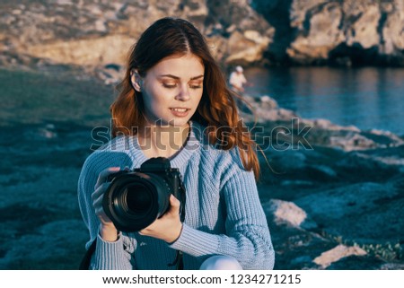 woman photographer with a camera in her hand in nature                