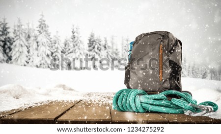 Winter landscape and backpack on table with snow 