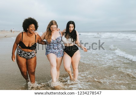 Cheerful plus size women enjoying the beach Royalty-Free Stock Photo #1234278547