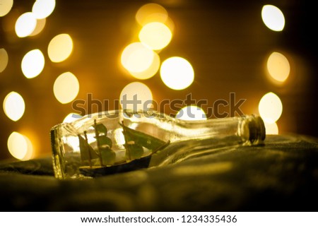 Ship on a bottle under the christmas lights