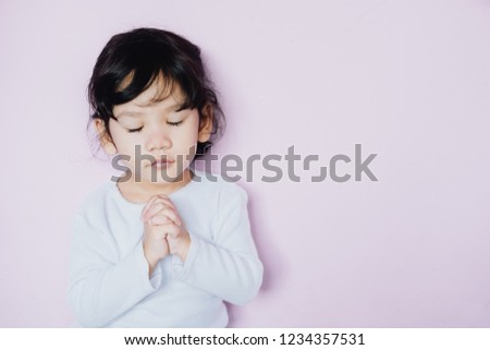 Little asian girl hand praying , spirituality and religion, Christianity concept.  Pray background.
