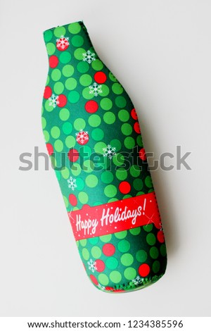 bright green bottle case with a picture of snowflakes on a bottle of Happy Holiday, Christmas, New Year concept