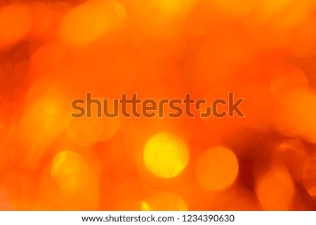 Bokeh. Holiday background. Christmas lights. Glitter. Defocused sparkles. New Year backdrop. Festive wallpaper. Blinks. Carnival. Bokeh retro style photo. Orange.
