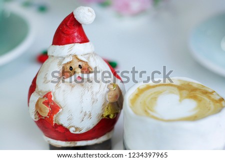 Santa Claus And white coffee on the white table.