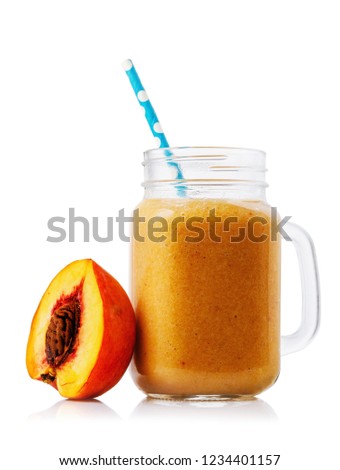 Smoothies in glass jar cooked from a peach, isolated on white background