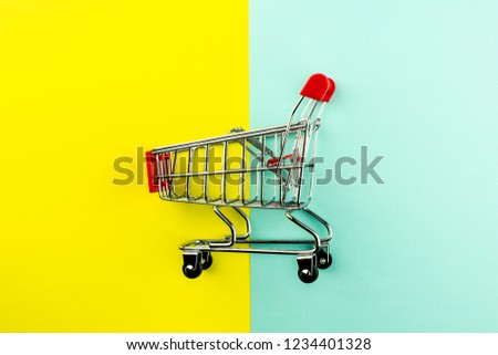 empty shopping cart on yellow and blue background. - for advertising and for copy space.