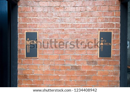 Front view of public restroom or toilet with man and women signs on brick wall decorate by vintage style in department store