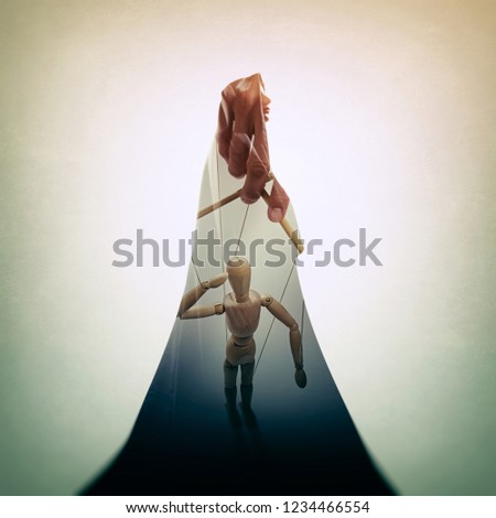 Concept of mind control. Silhouette of a woman in a cloak with marionette image. Double exposure.