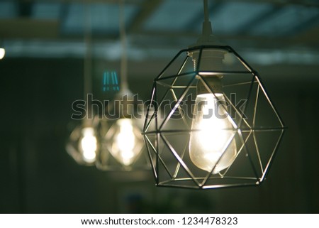 Vintage caged creative lamp light bulb in modern style for home or restaurant decor. Interior light design concept.
